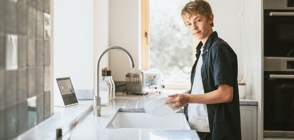 Boy washing dishes