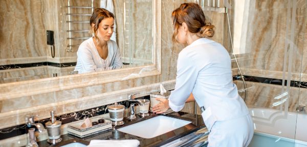 Housekeeper cleaning bathroom