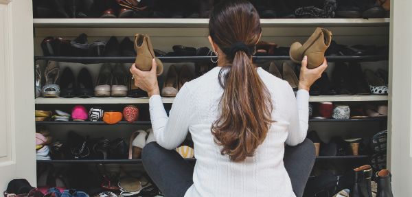 Woman organising shoes in her cupboard.