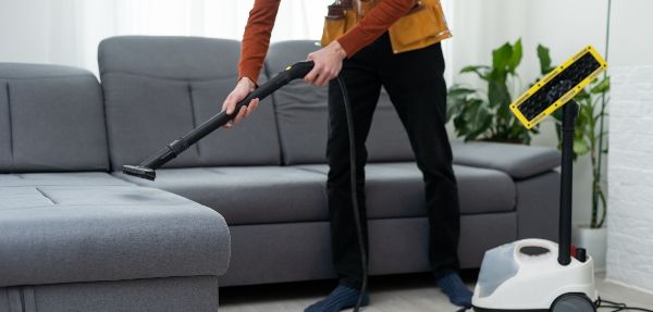 Process of deep furniture cleaning, removing dirt from a couch.