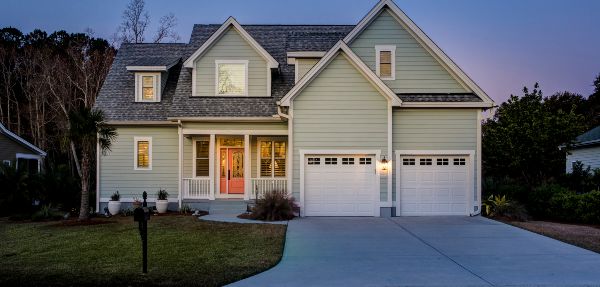 Front elevation of beautiful home lit up at twilight.