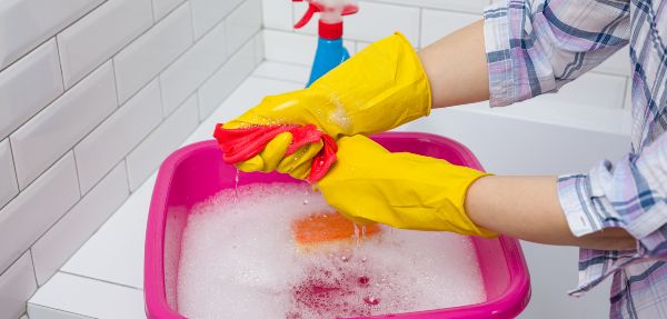 Woman cleaning in the bathroom at home.