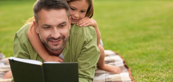 Father and daughter reading together.