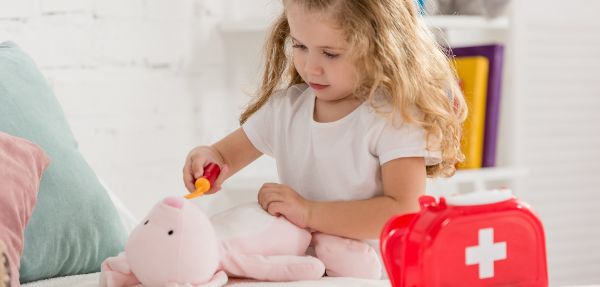 Adorable kid examining rabbit toy.