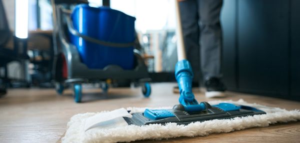 Person mopping a floor.