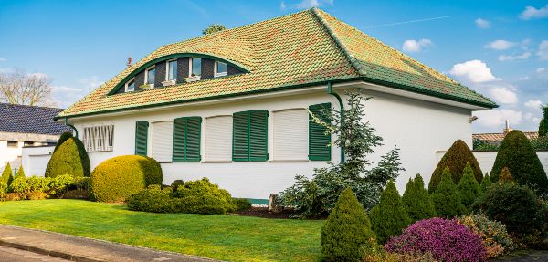 Façade of luxury detached house with a beautiful garden.