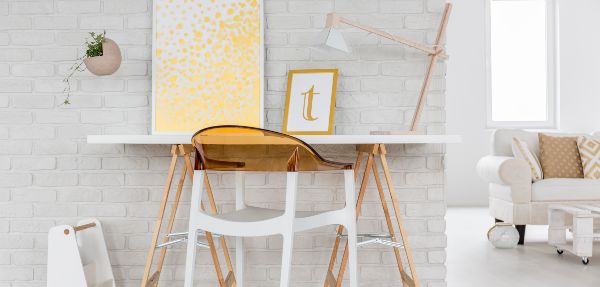 Clean and well-organised working desk with simple styling surrounding it.