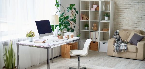 Clean and organised home office with a desk, chair, and storage cabinet. 