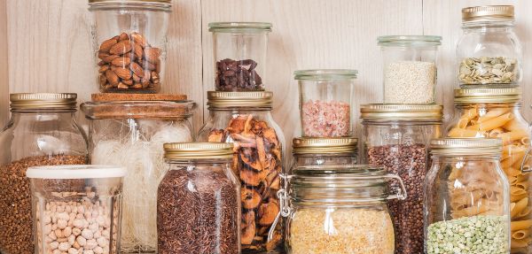 Shelf in the kitchen with various cereals and seeds.