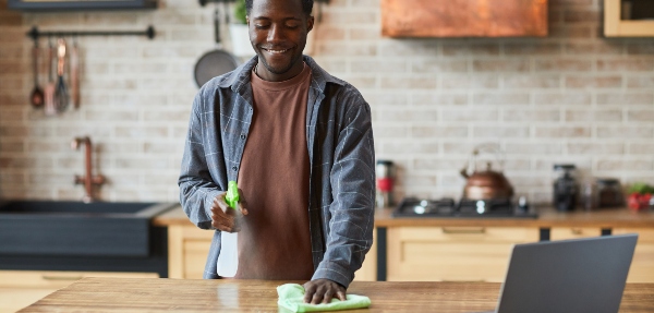 African American man cleaning his kitchen counter