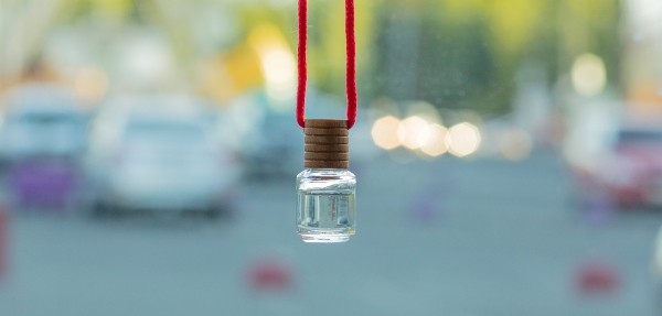 Car air freshener with a road-view in the background