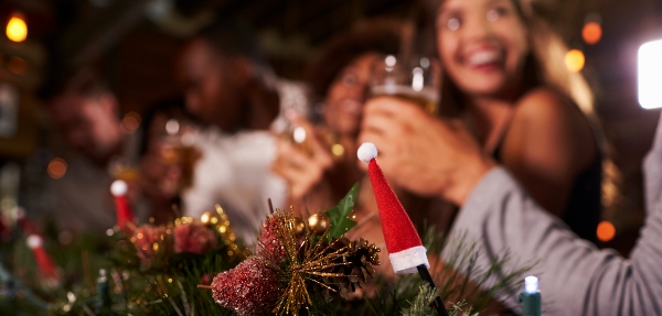 Christmas decorations at the forefront of a shot of a party