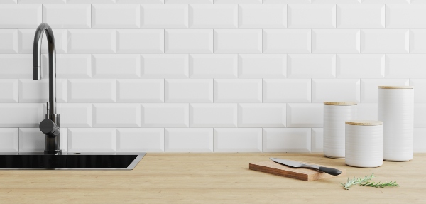 Cutting board with a knife on it on top of a kitchen counter with storage containers behind it