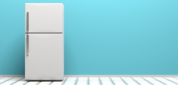 White fridge on a tiled floor with a blue background behind it