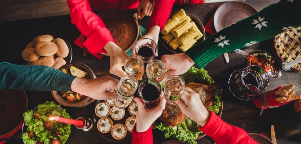 Bird's-eye view shot of friends' hands coming together to 'cling' their glasses in celebration