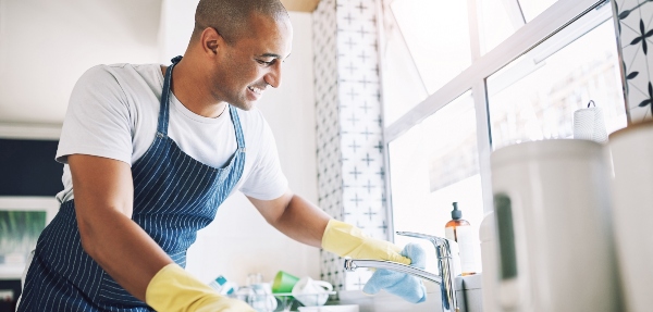 Man cleaning a kitchen sink