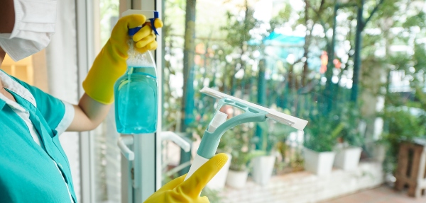 Close-up of a professional window cleaner doing their job