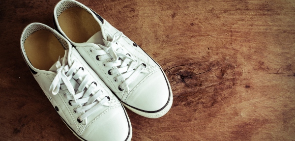 White canvas shoes on old wooden floor, Vintage tone