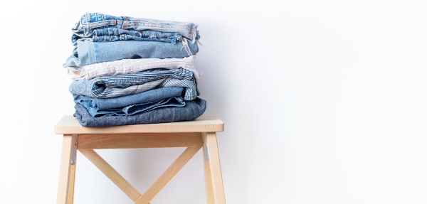 A pile of fresh laundry on a wooden chair