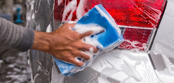 Close-up of a person's hand cleaning a car light