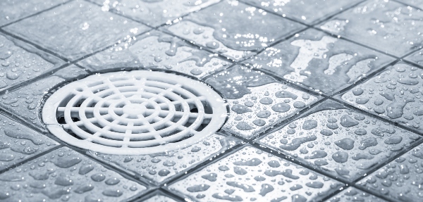 Shower drain with water droplets around it