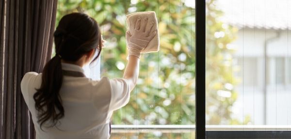 View from behind of a woman washing windows