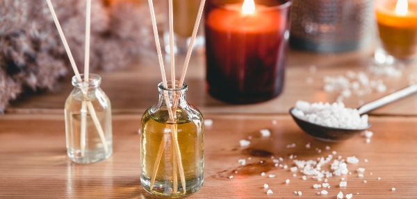 Reed air freshener with candle and eucalyptus branches.