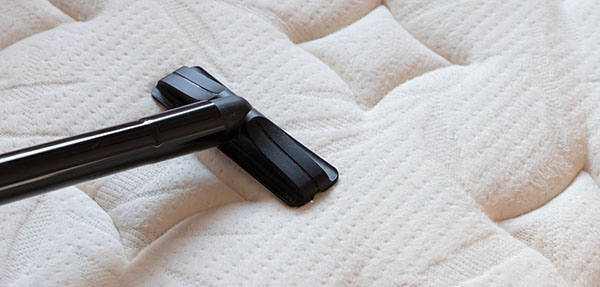 Close-up shot of a vacuum on a mattress