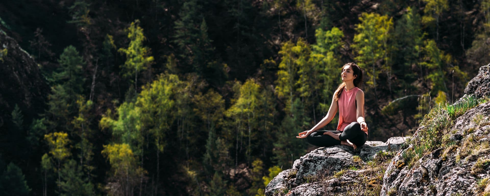 Woman doing yoga in the mountains.