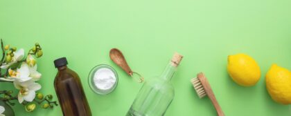 Jars and natural ingredients on a green background