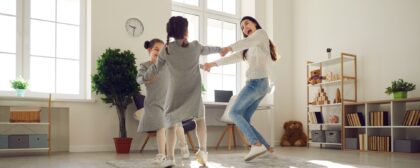 Mother and her daughters playing together at home