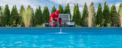 Professional Swimming Pool Technician Performing Seasonal Maintenance.